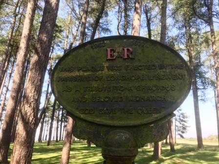 Commemorative plaque in the small wood on the summit