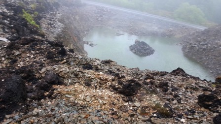 Disused quarry / spoil tip beside the summit