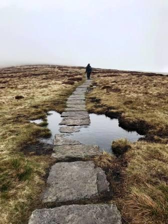 Marching on towards Kinder Low trig point