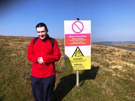 Liam by the firing range warning sign