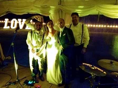 Band photo with bride and groom