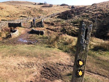 Bear right over the bridge and up the stone track