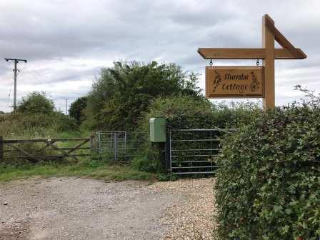 Footpath continues past the entrance to Shamba Cottage