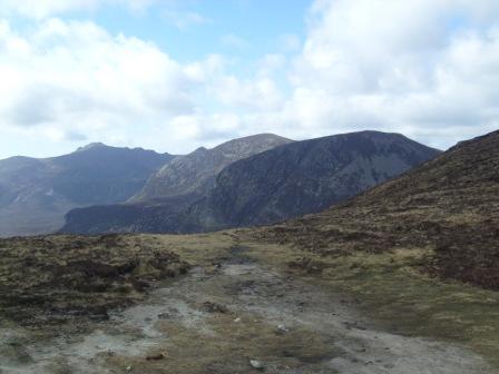 Looking towards (L-R): Slievemalagan GI/MM-006, Cove Mountain and Slieve Beg from the Mourne Wall between Slieve Donard GI/MM-001 and Slieve Commedagh GI/MM-002