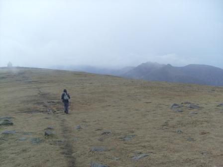 Jimmy walking back from the summit cairn to the Mourne Wall shelter