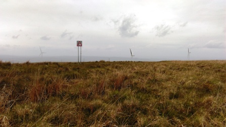 Summit is very close to the road - and a wind farm