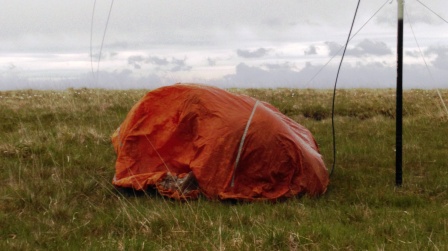 Jimmy operating in the bothy bag to shelter from the poor weather