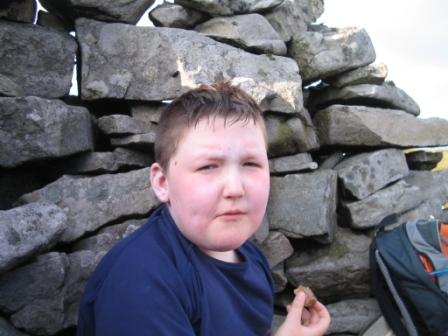 Liam enjoys a snack in the summit shelter