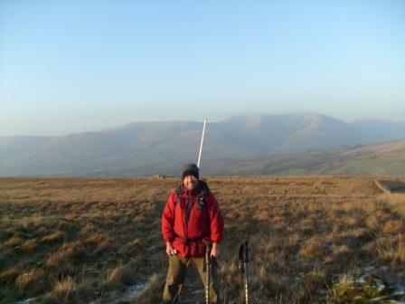 Tom halfway up, with the earlier Baugh Fell behind