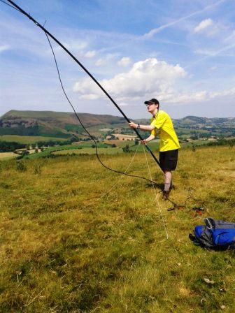 Jimmy erecting the MFD on Mynydd-y-briw, with Gyrn Moelfre in the background