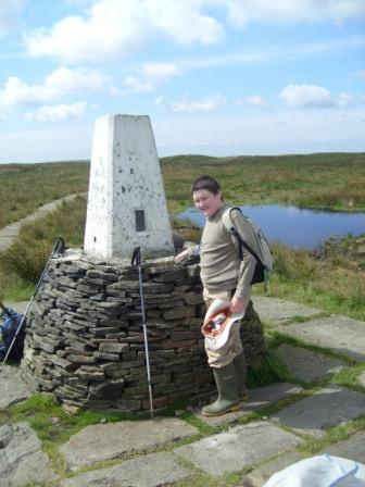 Liam arrives at the trig point