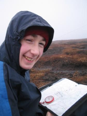 Jimmy studies the map and compass on Kinder