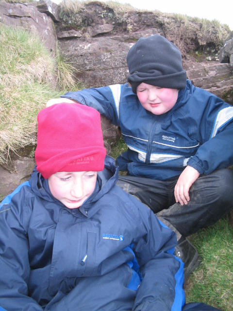 Jimmy and Liam trying to shelter from the ferocious wind while on the Welsh side of Black Mountain