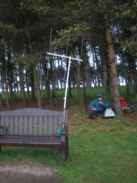 SOTA Beam with bench as mast support - Tom and Liam shelter in the wood behind!