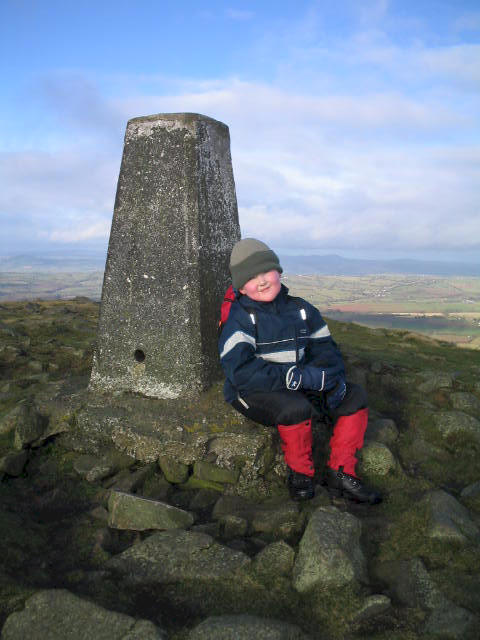 Liam poses by the trig point